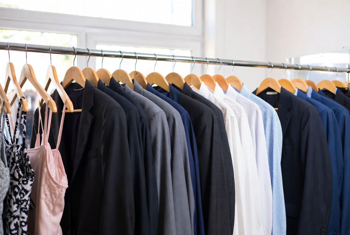 eatly pressed suits and elegant dresses hanging in a bright modern dry cleaning shop – Whiteleys Cleaners West Wickham